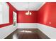 Dining room has hardwood floors, bright red walls, and white trim at 829 Lakeworth Cir, Lake Mary, FL 32746