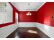 Formal dining room with bold red walls, hardwood floors, and wainscoting at 829 Lakeworth Cir, Lake Mary, FL 32746