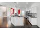 Open concept kitchen with bar seating, stainless steel appliances and dark wood flooring at 829 Lakeworth Cir, Lake Mary, FL 32746