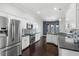 Modern kitchen with stainless steel appliances, granite counters and a blue tiled backsplash at 829 Lakeworth Cir, Lake Mary, FL 32746