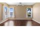 The living room offers hardwood floors and an abundance of natural light from the large windows at 829 Lakeworth Cir, Lake Mary, FL 32746