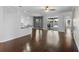 Open living space with dark wood floors and access to the kitchen and patio at 829 Lakeworth Cir, Lake Mary, FL 32746