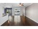 Bright living room features wood floors and sliding glass doors to the pool and lake at 829 Lakeworth Cir, Lake Mary, FL 32746