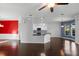 Open-concept living space with hardwood floors and view of modern kitchen at 829 Lakeworth Cir, Lake Mary, FL 32746