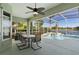 The screened-in patio features a dining table with views of the pool and lake at 829 Lakeworth Cir, Lake Mary, FL 32746