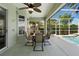 Inviting covered patio features an outdoor dining area with a ceiling fan, perfect for relaxing or entertaining at 829 Lakeworth Cir, Lake Mary, FL 32746