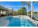 Enjoy the screened-in pool and spa with views of the lake and lush landscaping at 829 Lakeworth Cir, Lake Mary, FL 32746