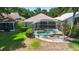 A screened-in lanai features a pool and meticulously maintained landscaping around the perimeter at 829 Lakeworth Cir, Lake Mary, FL 32746