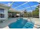 This home includes a screened-in pool and spa with outdoor dining space that overlooks lush landscaping at 829 Lakeworth Cir, Lake Mary, FL 32746
