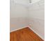 Walk-in closet featuring custom white shelving and hardwood floors at 829 Lakeworth Cir, Lake Mary, FL 32746
