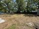 Expansive backyard featuring mature trees, a privacy fence, and plenty of room for outdoor activities and entertainment at 890 Emerald Dr, Mount Dora, FL 32757