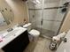 Clean bathroom features a glass-enclosed shower, modern vanity, and neutral tile flooring at 890 Emerald Dr, Mount Dora, FL 32757