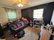 Comfortable bedroom with a ceiling fan, chalkboard wall, and a window with natural light at 890 Emerald Dr, Mount Dora, FL 32757