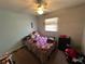 Cozy bedroom with carpeted floors, natural light, and a ceiling fan at 890 Emerald Dr, Mount Dora, FL 32757