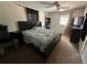 Spacious bedroom featuring carpeted floors, a ceiling fan, and two bright windows at 890 Emerald Dr, Mount Dora, FL 32757