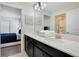 Spacious bathroom features double sinks, a large mirror, and a view to a well-decorated bedroom at 9034 Stinger Dr, Davenport, FL 33896