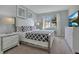 This bedroom includes patterned bedding, two nightstands, contemporary artwork, and bright natural lighting at 9034 Stinger Dr, Davenport, FL 33896