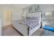 This bedroom features a bed with patterned bedding, two nightstands, contemporary artwork, and plush carpeting at 9034 Stinger Dr, Davenport, FL 33896