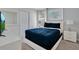 Comfortable bedroom features stylish blue bedding, a dresser with a TV, and a closet at 9034 Stinger Dr, Davenport, FL 33896