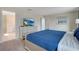 Serene bedroom featuring a comfortable queen bed, a TV, and a view of the en-suite bathroom at 9034 Stinger Dr, Davenport, FL 33896