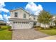 Charming two-story home featuring a paver driveway, two-car garage, and well-maintained landscaping at 9034 Stinger Dr, Davenport, FL 33896