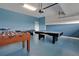 Spacious game room featuring a pool table, foosball, and air hockey for Gathering entertainment at 9034 Stinger Dr, Davenport, FL 33896