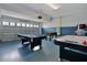 Bright game room with a pool table, air hockey, and foosball for recreational enjoyment at 9034 Stinger Dr, Davenport, FL 33896
