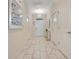 Inviting hallway with neutral walls, elegant tile flooring, and ample natural light at 9034 Stinger Dr, Davenport, FL 33896
