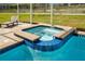Inviting pool and spa combo, tiled with blue accents, offering a relaxing outdoor retreat at 9034 Stinger Dr, Davenport, FL 33896