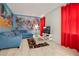 This living room includes a blue sofa, colorful wall art, a coffee table, and a flat-screen television at 9034 Stinger Dr, Davenport, FL 33896