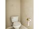 Modest half-bath with standard toilet, and beige walls with simple roll paper holder at 10585 Sw 38Th Ave, Ocala, FL 34476