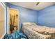 Bedroom featuring blue walls, window, closet and patterned bed at 10585 Sw 38Th Ave, Ocala, FL 34476