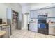 Kitchen with modern appliances, light gray cabinets, and an open pantry for storage at 10585 Sw 38Th Ave, Ocala, FL 34476