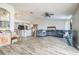 Open concept living room with wood-look tile flooring flowing into a kitchen with an island at 10585 Sw 38Th Ave, Ocala, FL 34476