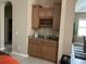 Home wet bar featuring ample counter space, brown cabinetry, and room for a mini fridge at 11120 Se 168Th Loop, Summerfield, FL 34491
