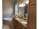 A bathroom showcasing a soaking tub, granite counters, and light wood cabinets at 11120 Se 168Th Loop, Summerfield, FL 34491