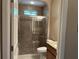 Modern bathroom showcasing a glass-enclosed shower and vanity with granite countertop at 11120 Se 168Th Loop, Summerfield, FL 34491