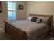 Comfortable bedroom featuring a large bed and window shutters at 11120 Se 168Th Loop, Summerfield, FL 34491