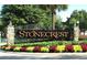 Stonecrest community entrance with lush landscaping and an elegant sign at 11120 Se 168Th Loop, Summerfield, FL 34491