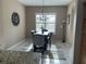 Dining room showcasing a modern chandelier, a neutral color palette, and natural light at 11120 Se 168Th Loop, Summerfield, FL 34491