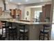 Kitchen with a breakfast bar overlooking the dining room, stainless steel appliances, and brown cabinetry at 11120 Se 168Th Loop, Summerfield, FL 34491