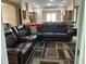 Spacious living room with an open floor plan, comfortable seating, and easy access to the kitchen and dining area at 11120 Se 168Th Loop, Summerfield, FL 34491