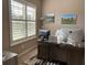 Bright office with large window and wood desk, creating an inviting workspace at 11120 Se 168Th Loop, Summerfield, FL 34491