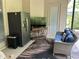 Cozy screened patio with comfortable seating, a fridge and outdoor decor, creating a relaxed atmosphere at 11120 Se 168Th Loop, Summerfield, FL 34491