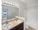 Bathroom with double sinks, large mirror, and tub-shower combination at 1123 Hacienda Cir, Kissimmee, FL 34741