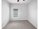 A bright bedroom with soft gray carpet and a window with natural light at 1123 Hacienda Cir, Kissimmee, FL 34741