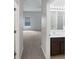Bedroom doorway view through hall to bathroom with double vanity and shower at 1123 Hacienda Cir, Kissimmee, FL 34741
