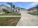 Charming single-story home with a well-maintained lawn and a two-car garage at 1123 Hacienda Cir, Kissimmee, FL 34741