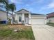 Charming single-story home with a well-maintained lawn and a two-car garage at 1123 Hacienda Cir, Kissimmee, FL 34741