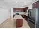 Modern kitchen with stainless steel appliances, granite countertops, and a center island at 1123 Hacienda Cir, Kissimmee, FL 34741